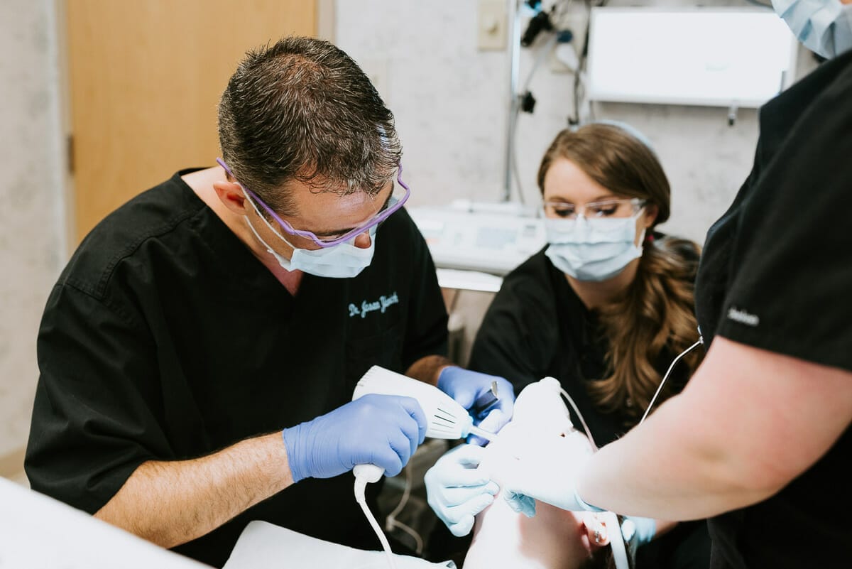 doctor yanich and his team performing oral surgery