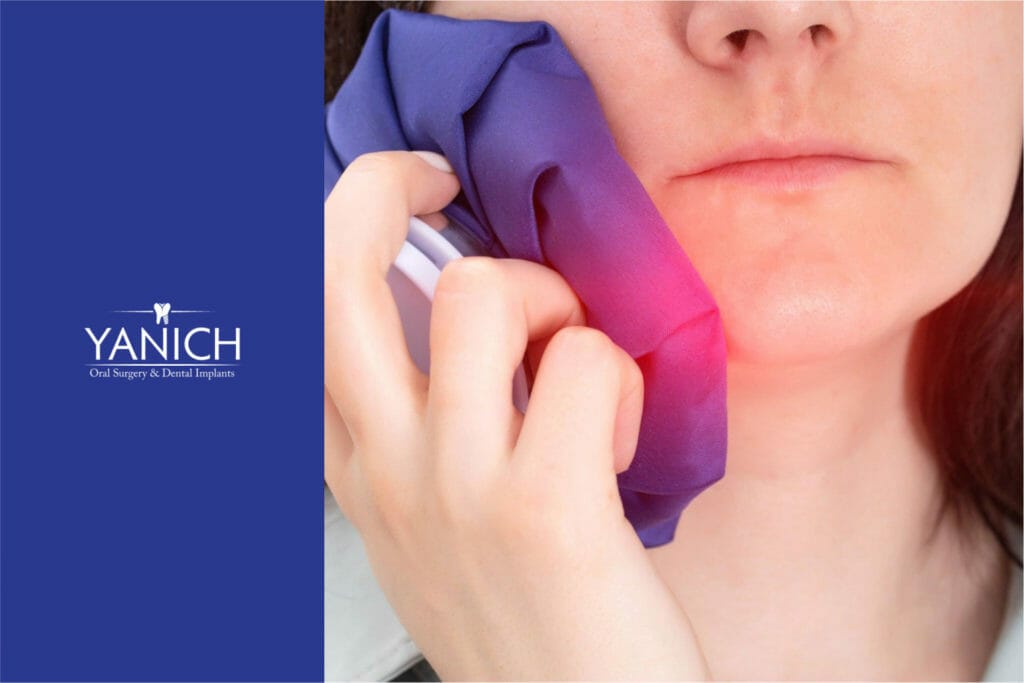 Image of a woman applying an ice pack to her jaw to alleviate pain and swelling after wisdom tooth removal.