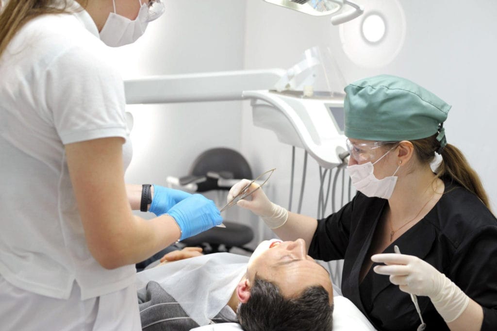 doctors preparing patient for oral surgery
