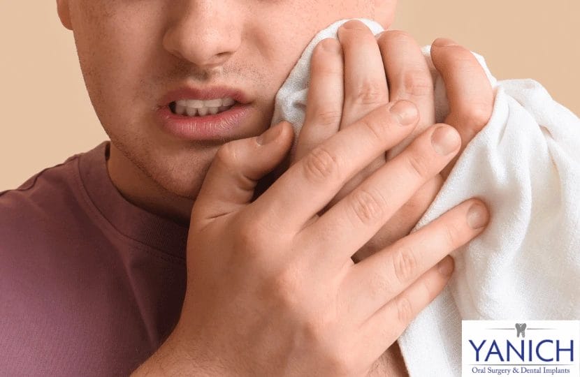 Man applying cold compress for wisdom tooth pain