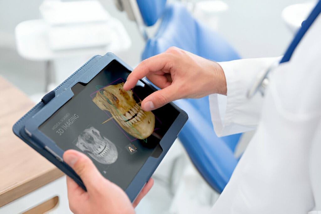 A dentist's hand interacting with a 3D dental scan on a tablet, showcasing detailed images of a patient's skull and teeth.